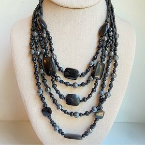 Multistrand layered black and gray mixed media necklace with glass seed beads